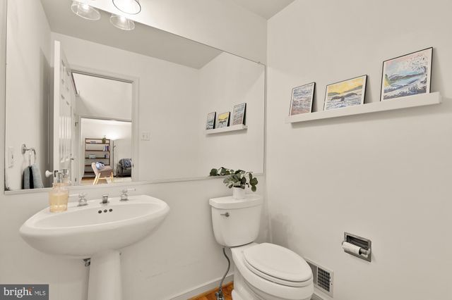 a bathroom with a sink mirror and toilet