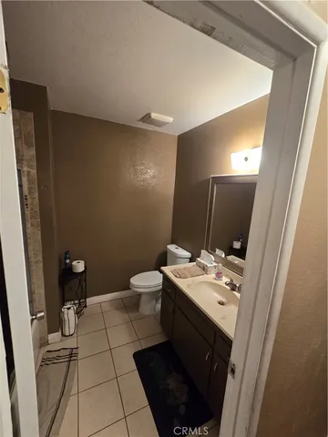 a bathroom with a sink a toilet a shower a mirror and vanity