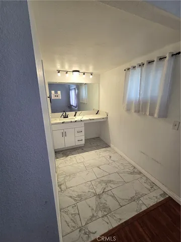 a bathroom with a toilet sink and a mirror