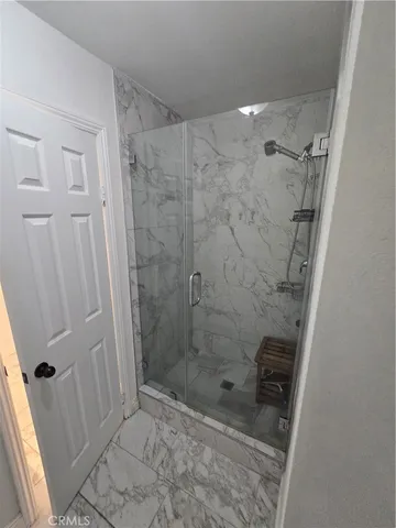 a view of a hallway with wooden floor and stairs