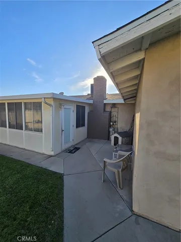 a view of a terrace with furniture and a garden