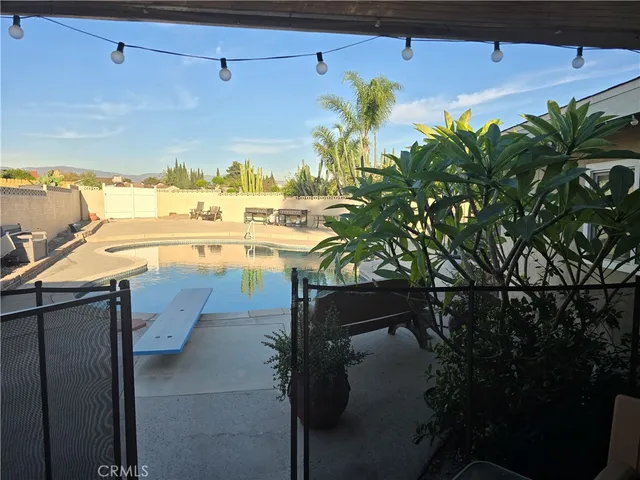 a view of a chair and table in the back yard