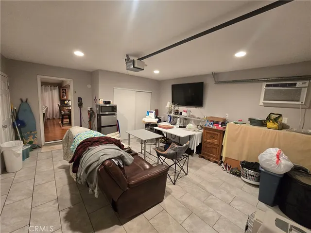 a living room with furniture a rug and a projector