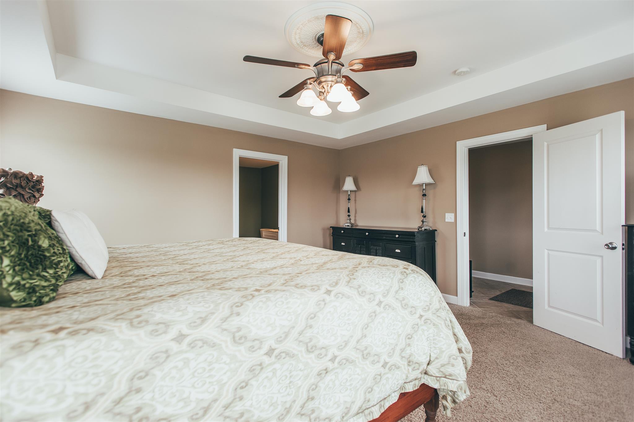 498 Canoe Branch Road Castalian Springs, TN 37031 - Photo 12 of 30 a spacious bedroom with a bed and a chandelier