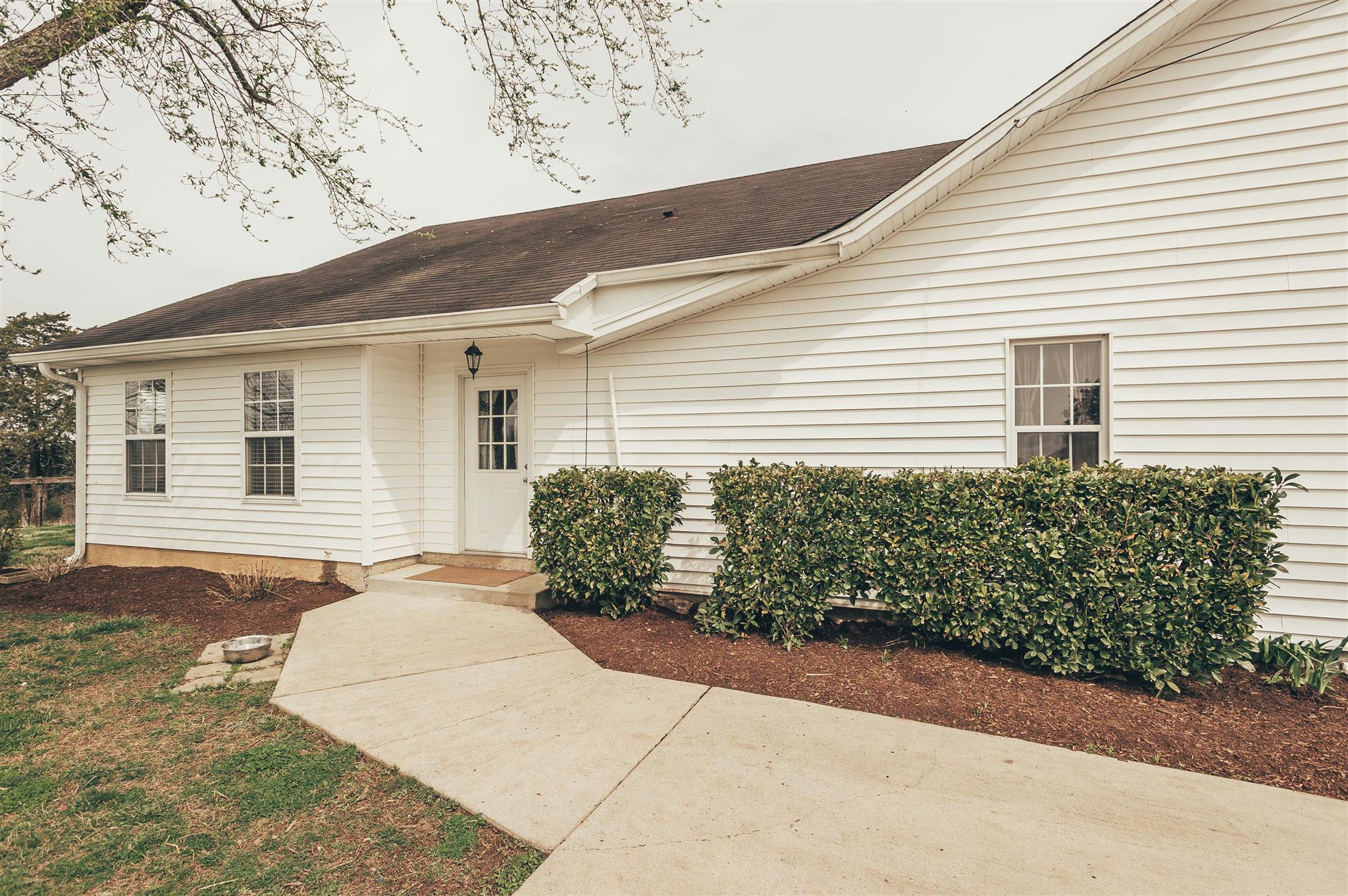 498 Canoe Branch Road Castalian Springs, TN 37031 - Photo 22 of 30 a front view of a house with a garden