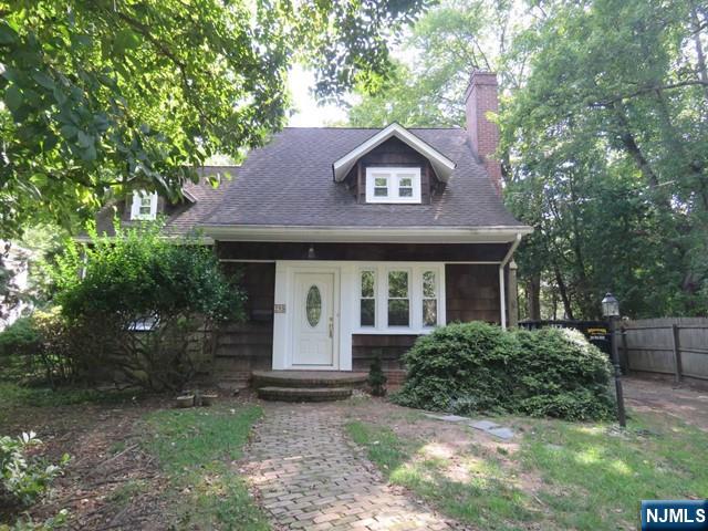 289 Hardenburgh Avenue Demarest, NJ 07627 - Photo 2 of 43 a front view of a house with a garden