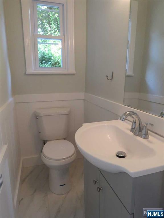 289 Hardenburgh Avenue Demarest, NJ 07627 - Photo 23 of 43 a bathroom with a sink a toilet and a mirror