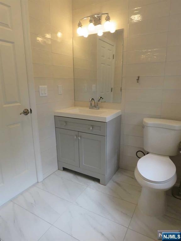 289 Hardenburgh Avenue Demarest, NJ 07627 - Photo 35 of 43 a bathroom with a toilet sink and mirror