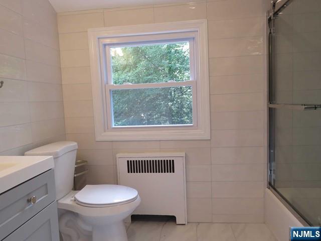 289 Hardenburgh Avenue Demarest, NJ 07627 - Photo 36 of 43 a bathroom with a sink toilet and window