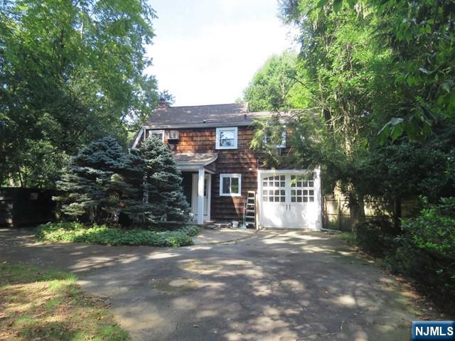 289 Hardenburgh Avenue Demarest, NJ 07627 - Photo 41 of 43 a front view of a house with a yard and trees
