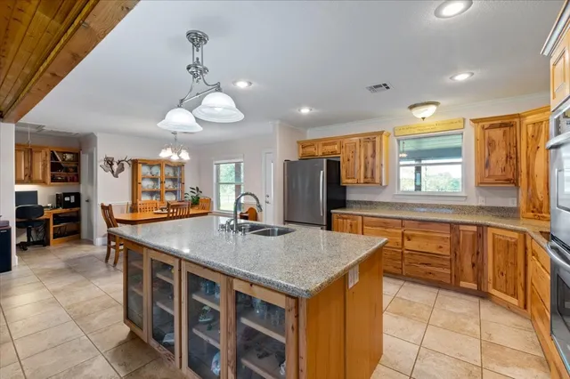a kitchen with stainless steel appliances granite countertop a sink and a refrigerator