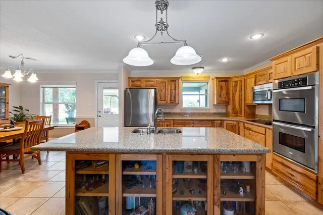 a kitchen with stainless steel appliances granite countertop a stove refrigerator and cabinets