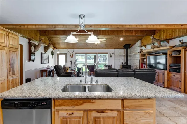 a kitchen with stainless steel appliances granite countertop a sink and a counter space