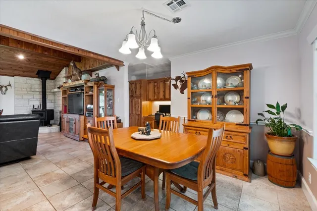 a view of a dining room with furniture and chandelier