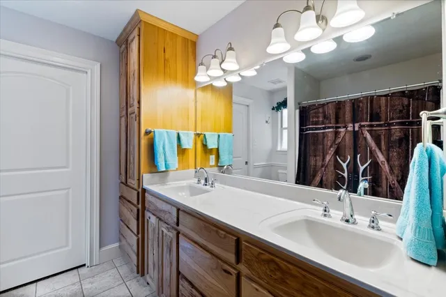 a bathroom with a sink vanity and a mirror