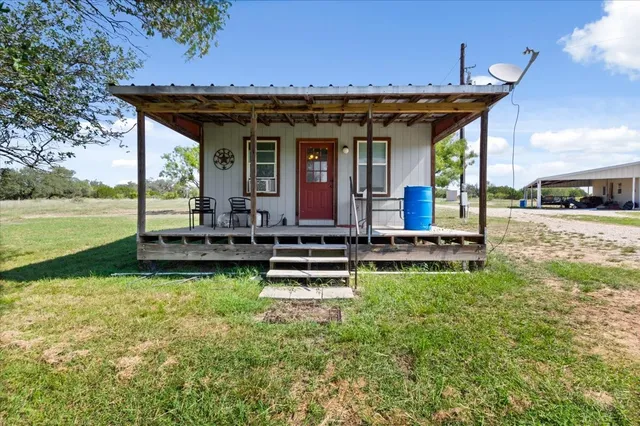 a view of a house with backyard porch and sitting area
