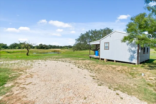 a view of a house with a yard and sitting area