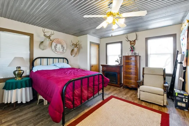 a bed sitting in a bedroom next to a window