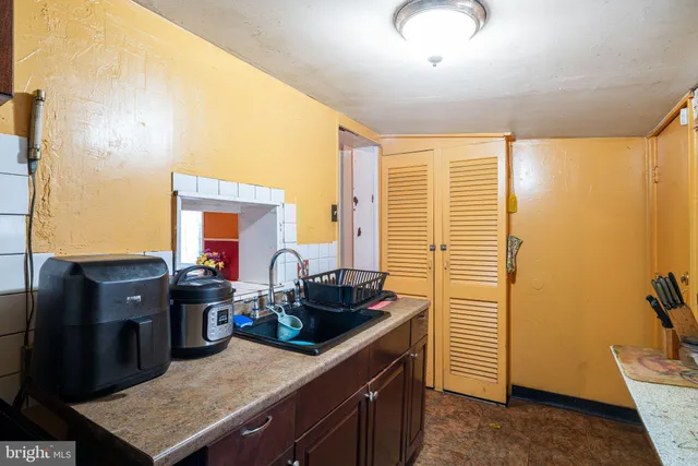 a kitchen with a sink and a refrigerator