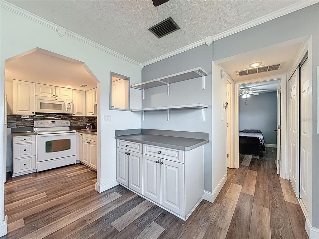 11832 Boynton Lane, Unit 24B New Port Richey, FL 34654 - Photo 15 of 42 a kitchen with stainless steel appliances a stove top oven and cabinets