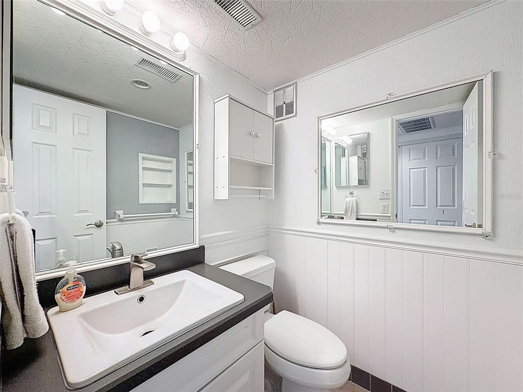 11832 Boynton Lane, Unit 24B New Port Richey, FL 34654 - Photo 18 of 42 a bathroom with a sink mirror toilet and shower