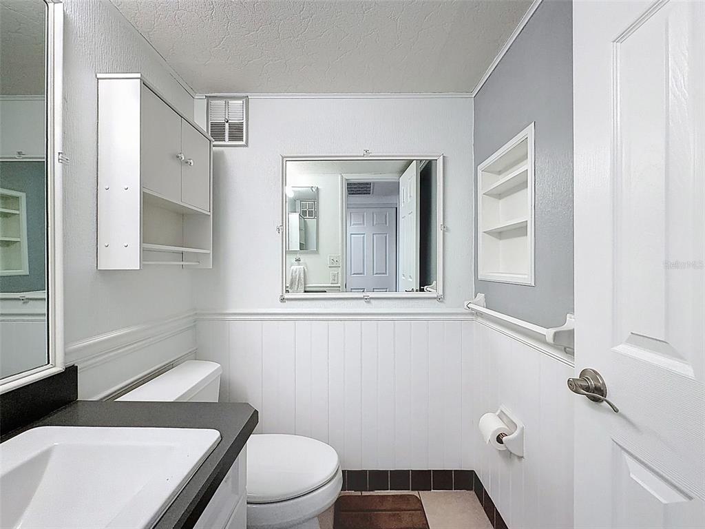 11832 Boynton Lane, Unit 24B New Port Richey, FL 34654 - Photo 19 of 42 a bathroom with a sink toilet and window