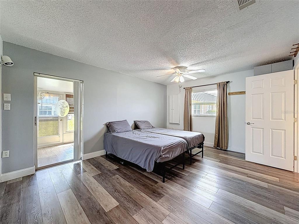 11832 Boynton Lane, Unit 24B New Port Richey, FL 34654 - Photo 21 of 42 a spacious bedroom with a bed and a window