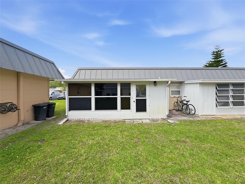 11832 Boynton Lane, Unit 24B New Port Richey, FL 34654 - Photo 30 of 42 a view of a house with a garden and yard