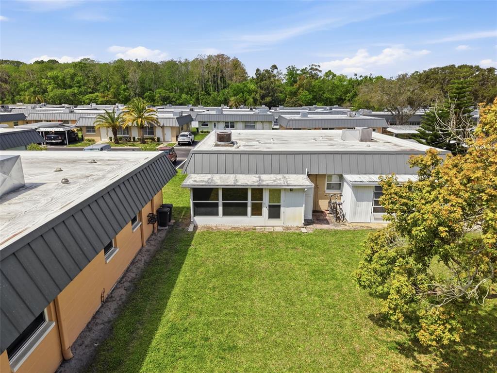 11832 Boynton Lane, Unit 24B New Port Richey, FL 34654 - Photo 31 of 42 a view of a house with a yard