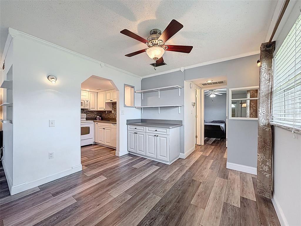 11832 Boynton Lane, Unit 24B New Port Richey, FL 34654 - Photo 10 of 42 a kitchen with stainless steel appliances a refrigerator and a stove top oven