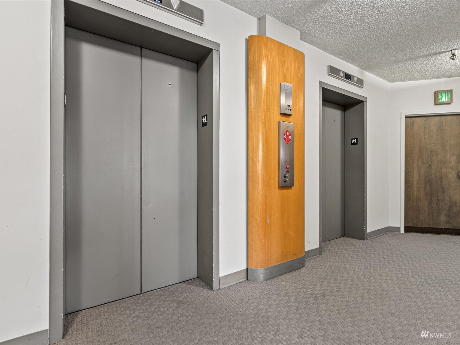 1300 University Street, Unit 2C Seattle, WA 98101 - Photo 18 of 20 a view of a hallway with wooden shelves