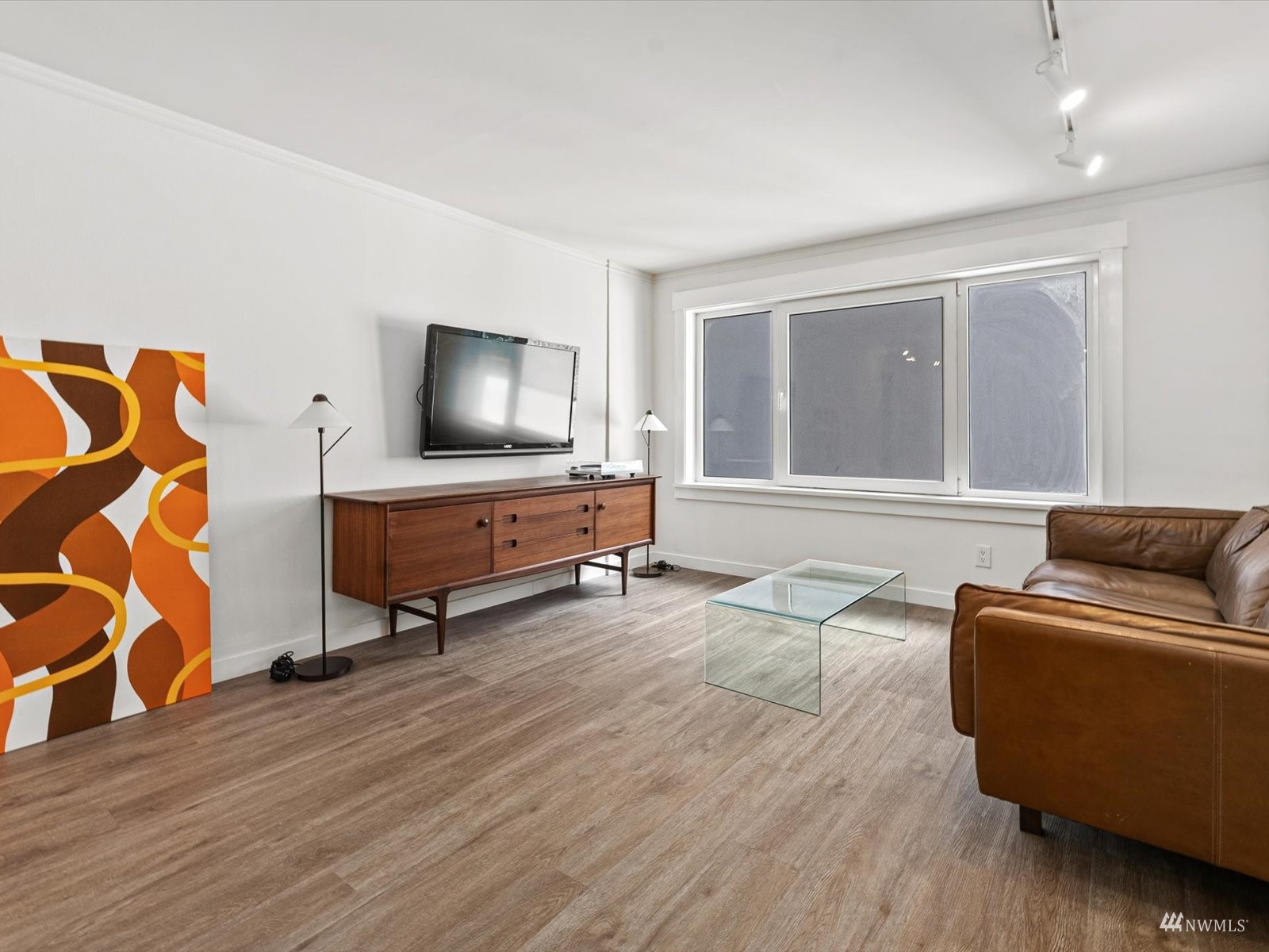 1300 University Street, Unit 2C Seattle, WA 98101 - Photo 2 of 20 a living room with furniture and a flat screen tv