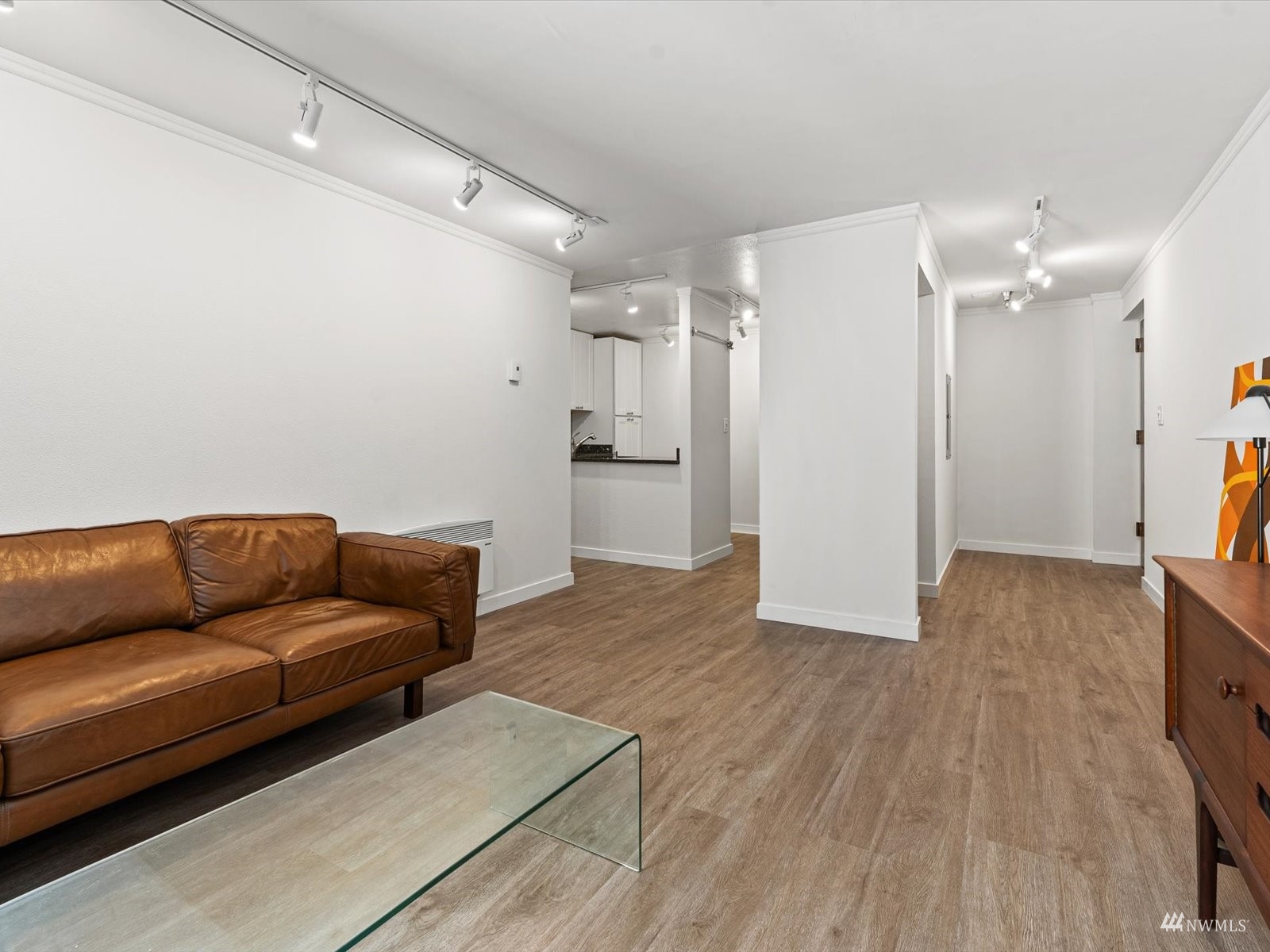 1300 University Street, Unit 2C Seattle, WA 98101 - Photo 4 of 20 a living room with furniture and a wooden floor