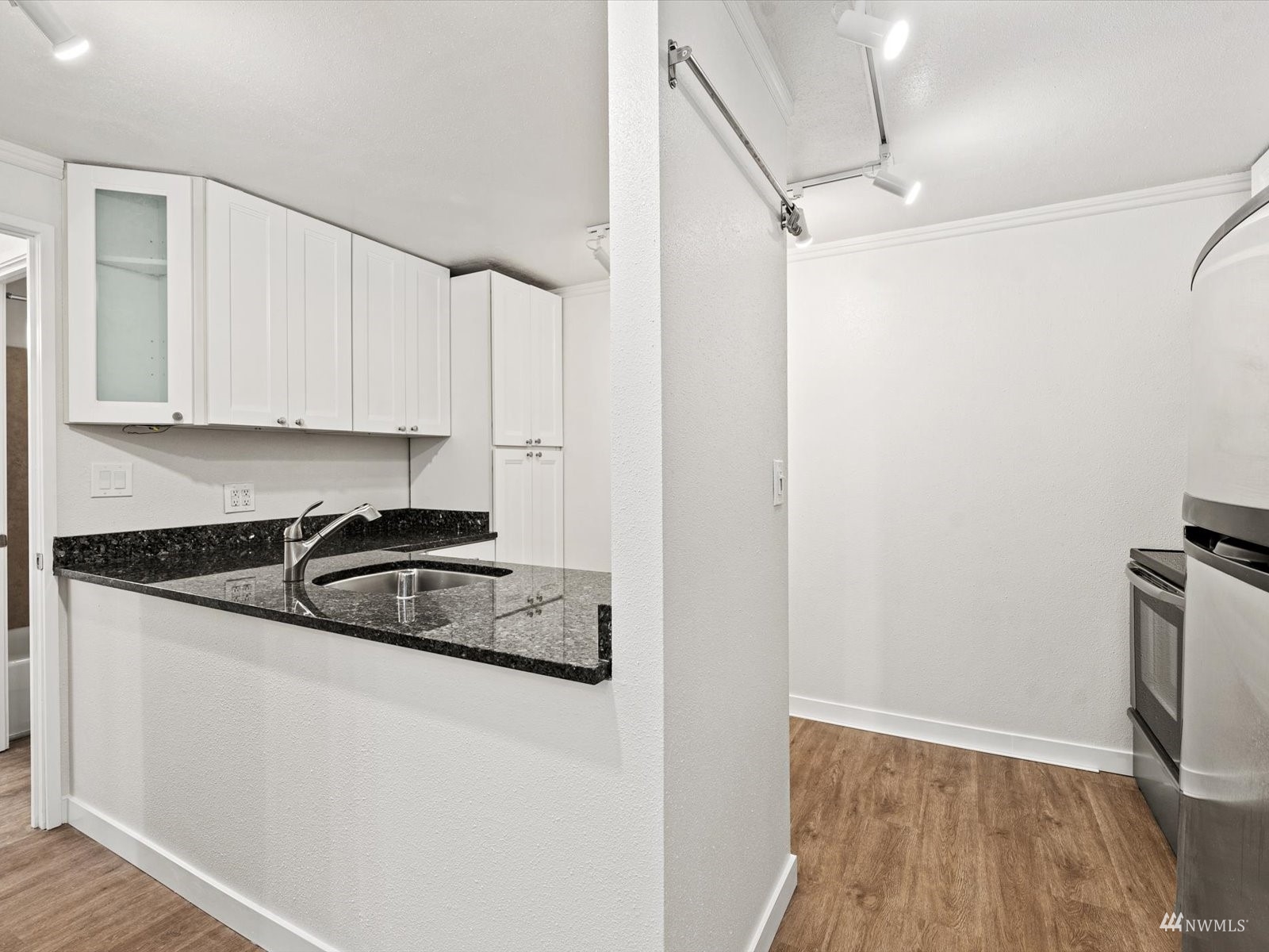 1300 University Street, Unit 2C Seattle, WA 98101 - Photo 5 of 20 a kitchen with granite countertop a sink and a stove top oven
