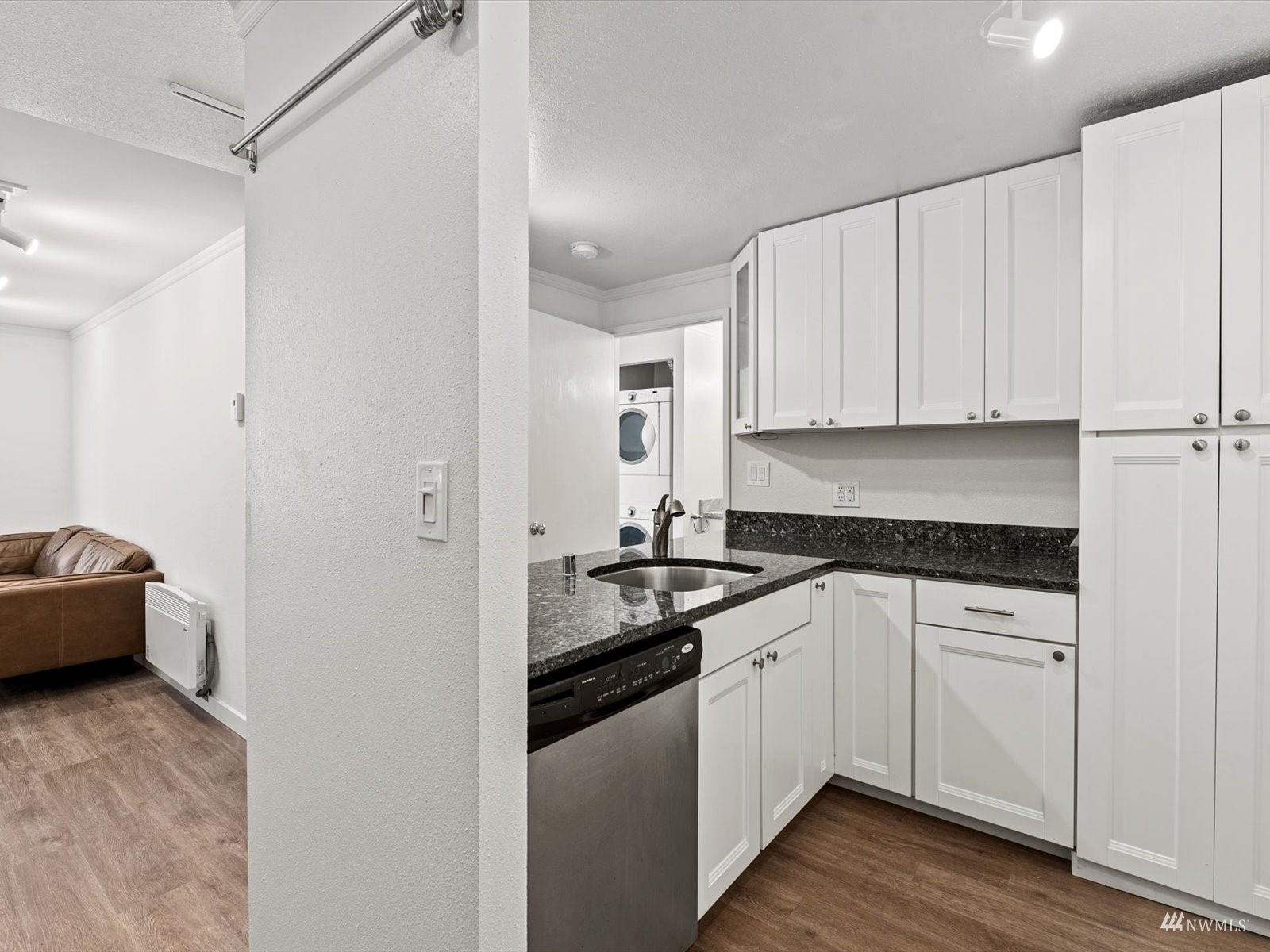 1300 University Street, Unit 2C Seattle, WA 98101 - Photo 6 of 20 a kitchen with stainless steel appliances granite countertop a sink and cabinets with wooden floor