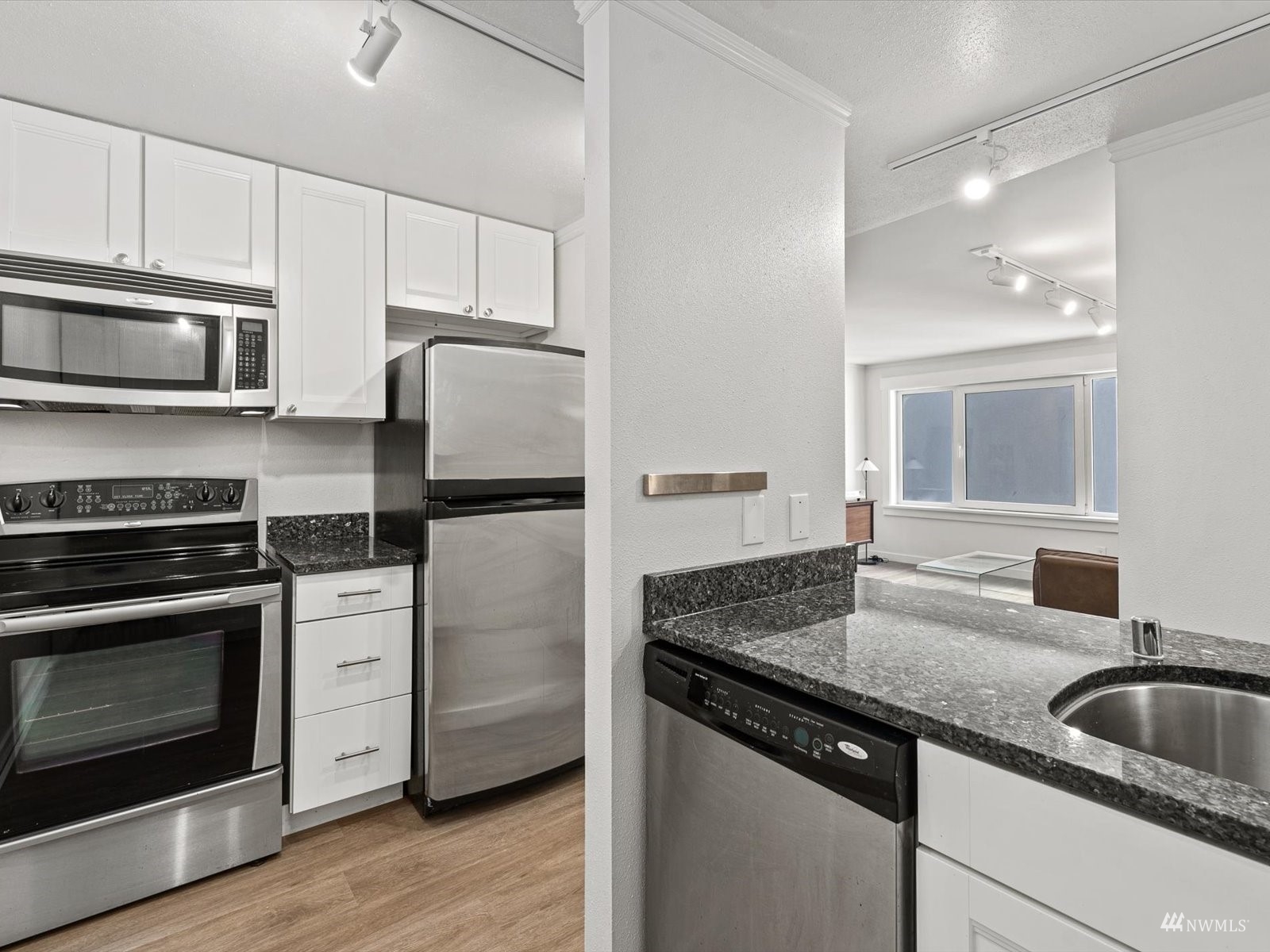 1300 University Street, Unit 2C Seattle, WA 98101 - Photo 7 of 20 a kitchen with stainless steel appliances granite countertop a sink stove and refrigerator