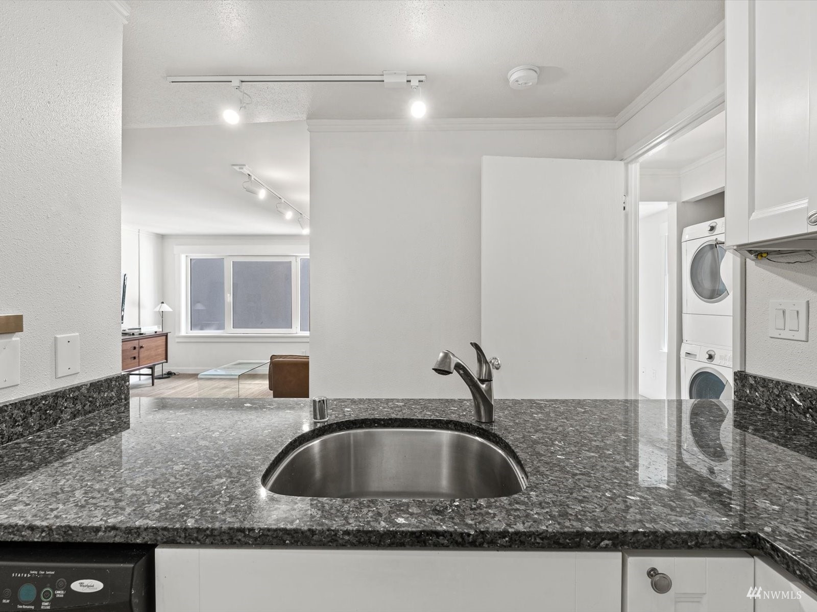 1300 University Street, Unit 2C Seattle, WA 98101 - Photo 8 of 20 a kitchen with granite countertop a sink and a wooden cabinets