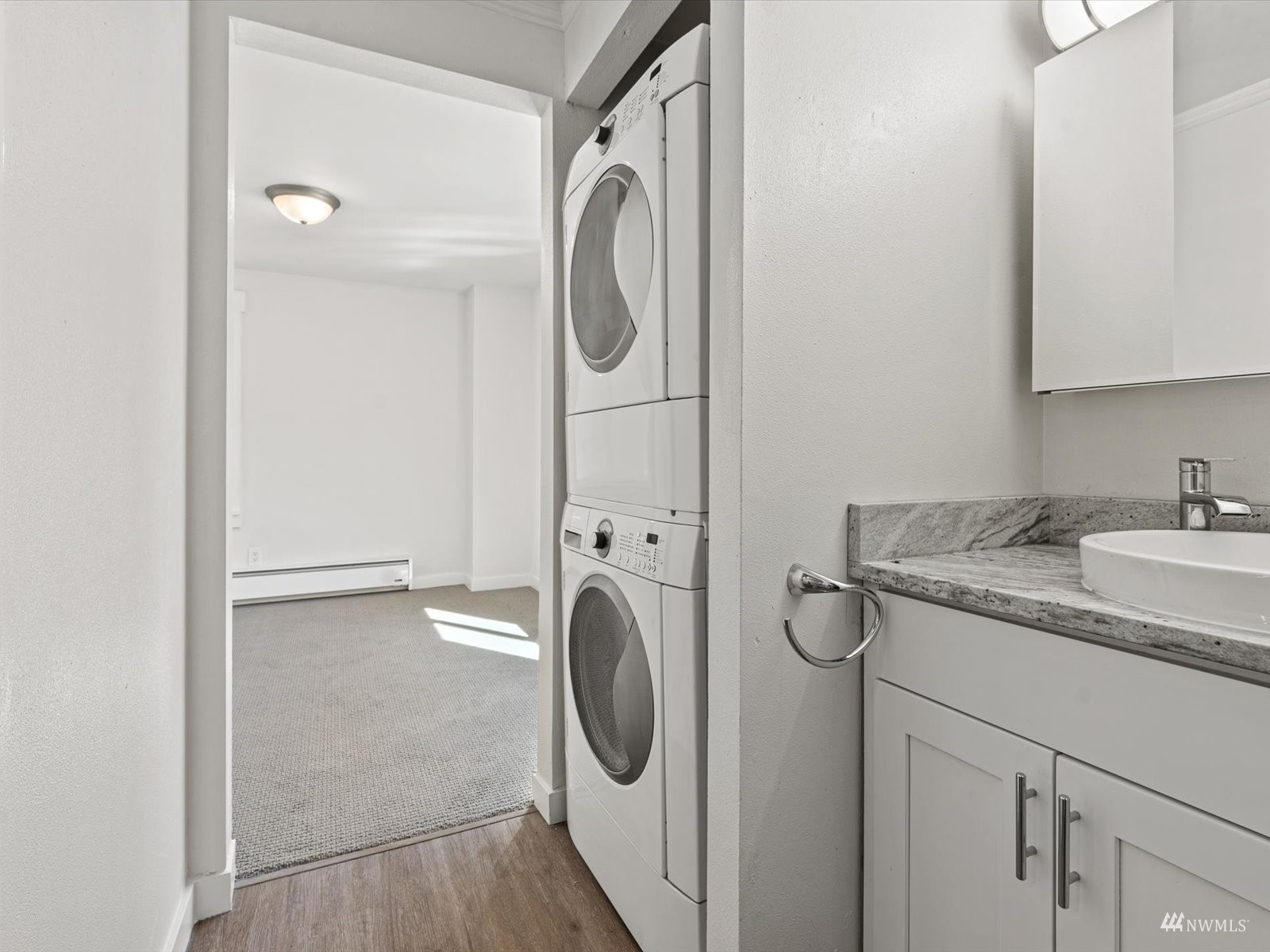 1300 University Street, Unit 2C Seattle, WA 98101 - Photo 10 of 20 a bathroom with a granite countertop sink and a mirror