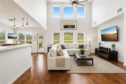 a living room with furniture and a wooden floor
