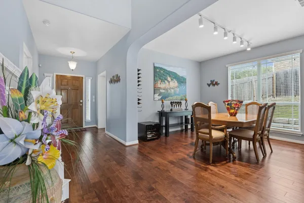 a view of a dining room with furniture and wooden floor