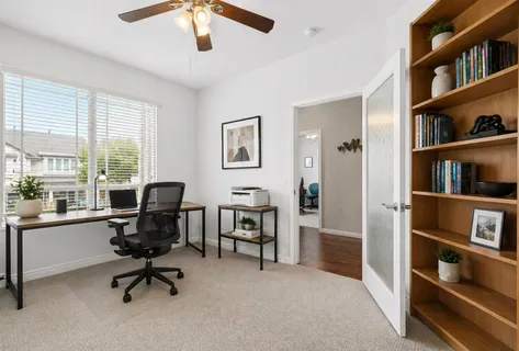 a spacious bedroom with a bed couch and a window