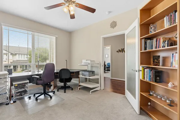 a spacious bedroom with a bed couch and a window