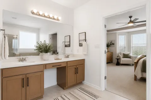 a kitchen with a stove a sink dishwasher a dining table and chairs with wooden floor
