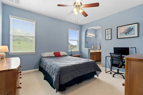an empty room with closet and a ceiling fan