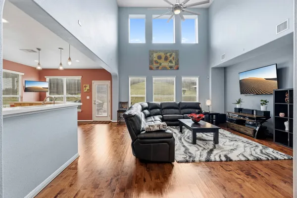 a living room with furniture and a wooden floor