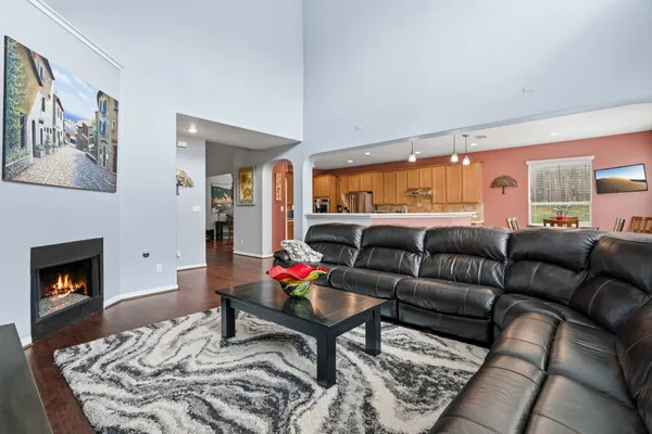 a kitchen with counter top space a sink appliances and living room view