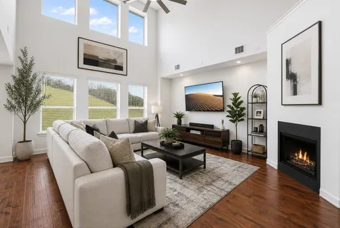 a kitchen with stainless steel appliances granite countertop a stove a sink and a dining table with granite countertop wooden floor