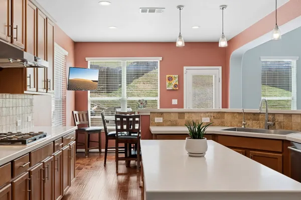 a dining room with furniture and wooden floor