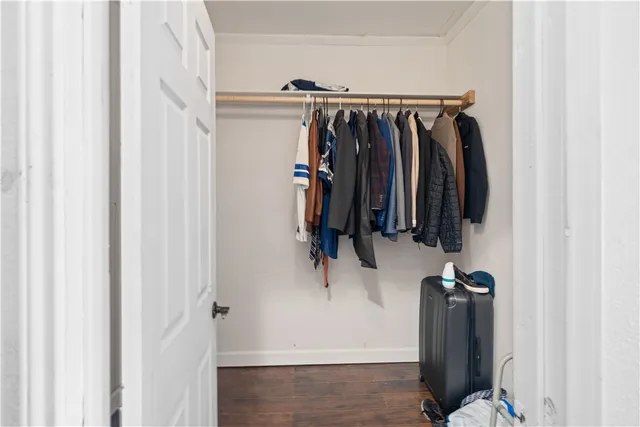 a view of walk in closet with clothes
