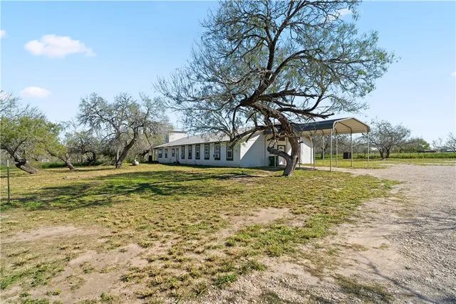 a swimming pool with outdoor seating and yard
